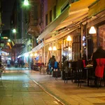 A narrow street in Istanbul with lots of restaurants and people sitting outside